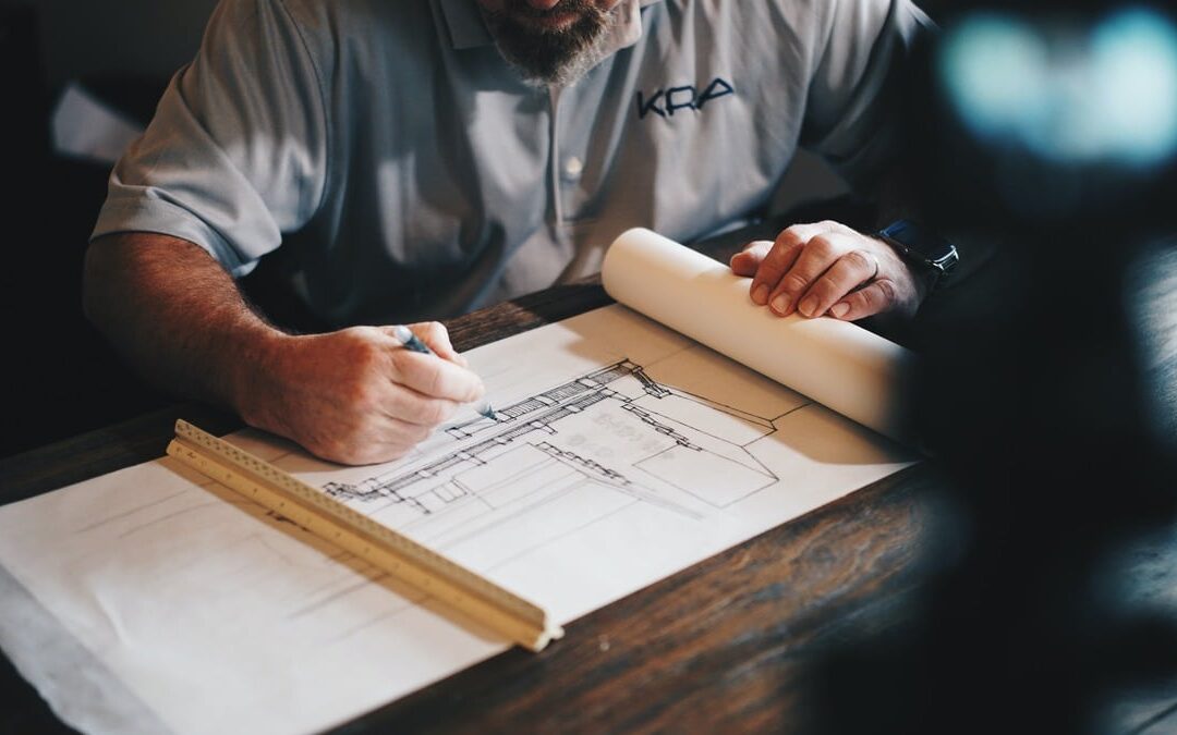 Expert planning services: Professional reviewing building plans and designs for a new home